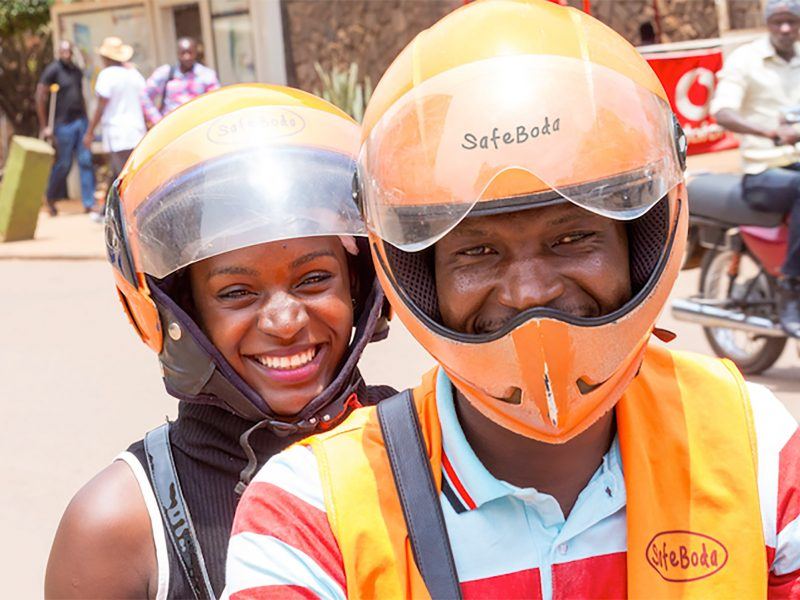 SafeBoda motorcycle rider with lady passenger on back
