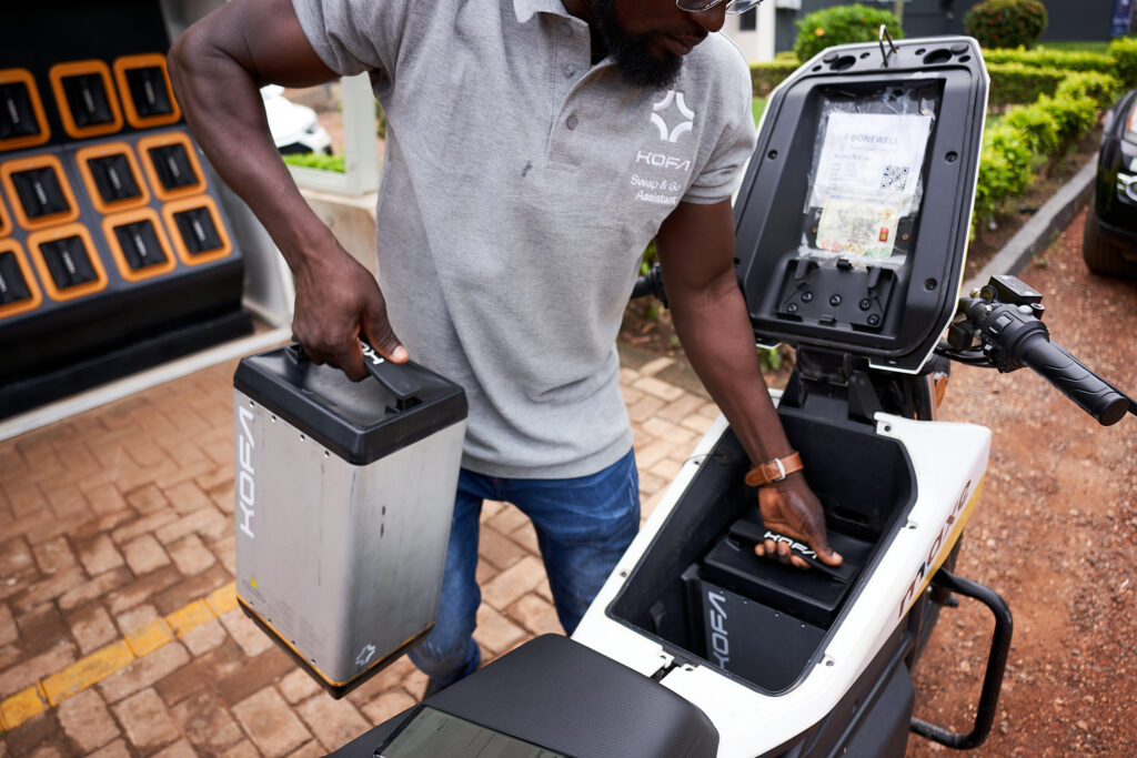 Man swamping batteries for an electric motorcycle